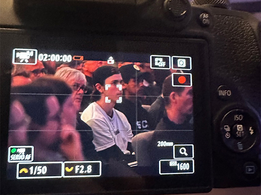 Camera framed on a group of young men in a church congregation during teaching